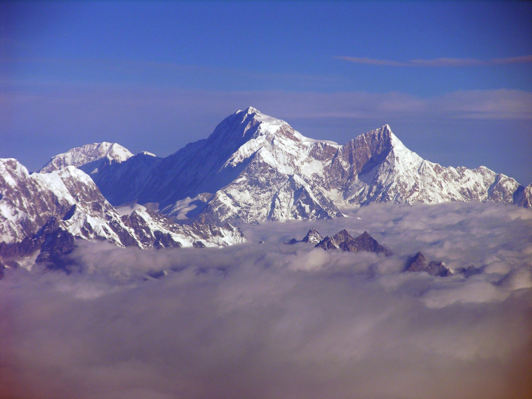Kangchenjunga 01 04 Mountain Flight Shishapangma Long View Shishapangma, the 14th highest mountain in the world at 8012m, shines in the early morning sun from Kathmandu�s Mountain flight. The steep and treacherous southwest face is in shadow on the left. The north face is just visible in the sun on the right. On the far right the pointy rocky peak is Phola Gangchen (7716m), first climbed in 1981, and to its left is Shishapangma�s East face.